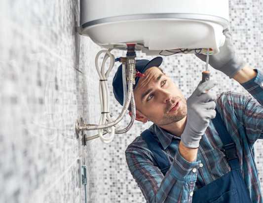 A man working on the wall of his home