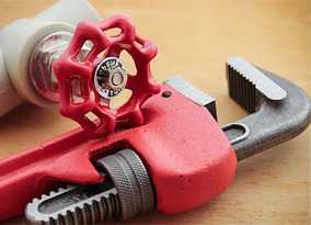 A red pipe wrench and a red handle